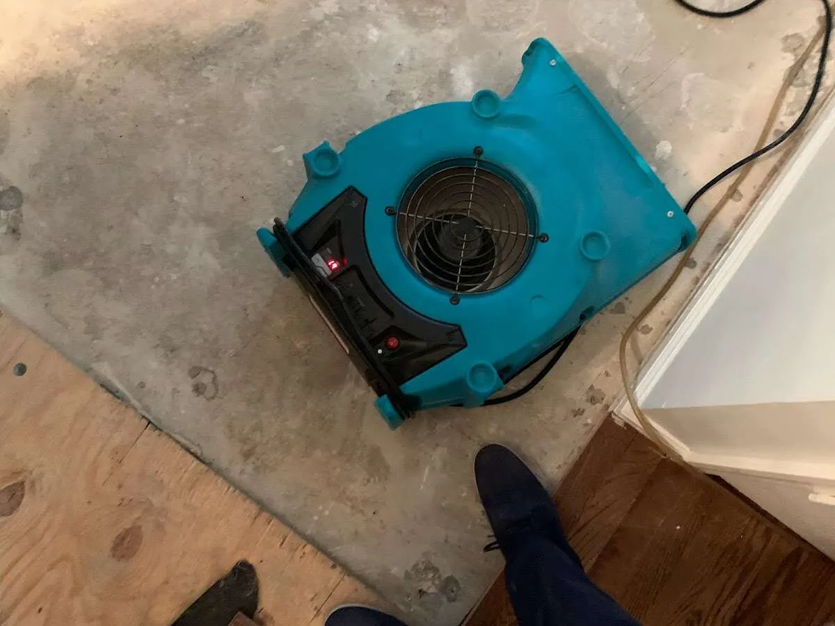 Air mover drying subfloor during Commercial Water Damage Restoration in Tega Cay